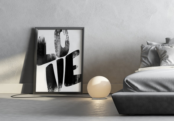 Love in grungy bold lettering on a poster in a modern bedroom