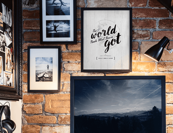 modern teen's room with adventure photos and a framed The World Needs What You've Got print framed on the wall