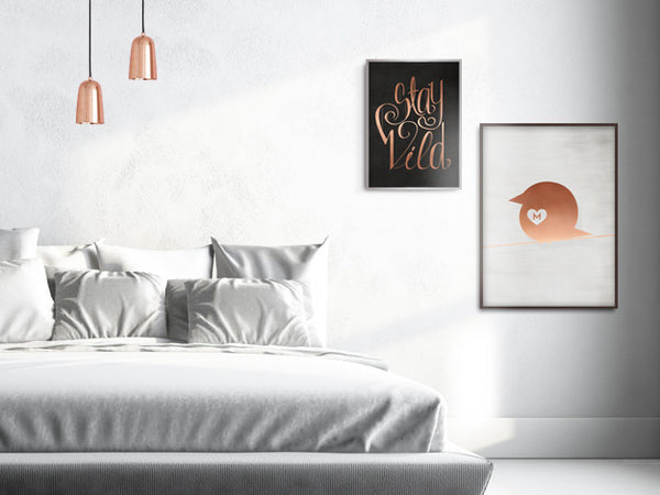 Picture of a bedroom with copper accents, Stay Wild poster and Copper Chirp poster on the wall
