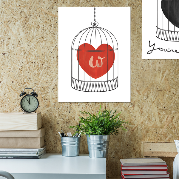 Teenager's room with our print with a watercolor red heart in a bird cage. have an initial set in the heart. 