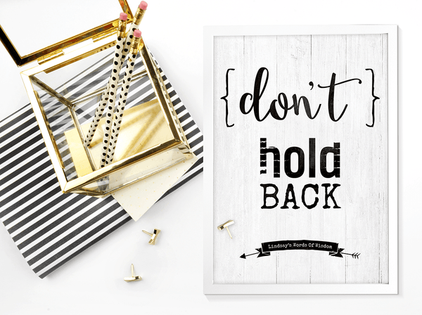 Don't Hold Back framed personalized print on a desk with black and gold accents