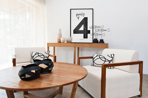 A modern room with neutral decor and a large Family of 4 Personalized Print displayed on the wall