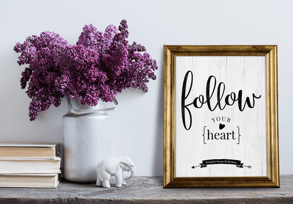 Desk with a framed Follow Your Heart personalized print