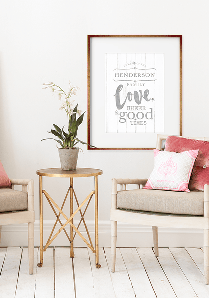 Modern room with gold accents and a framed Home Of Family Love print on the wall