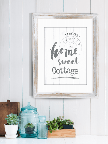 shiplap wall with decorations and a framed personalized print "Home Sweet Cottage"
