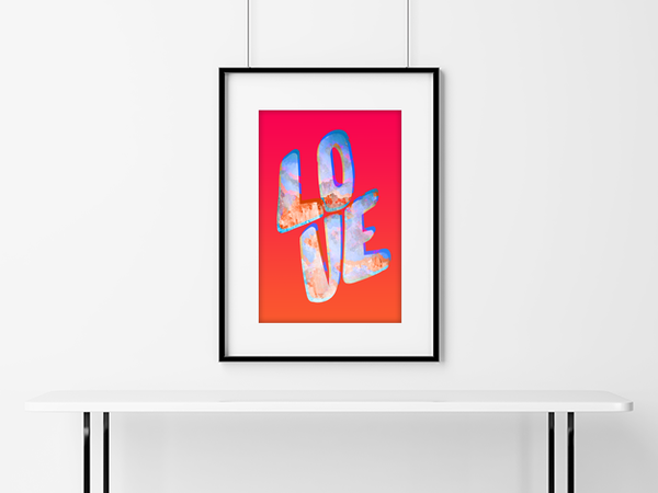 Love In Colour poster hanging in a matted frame on a brick wall