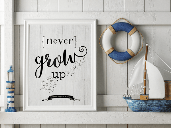 Children's room with nautical decor and a framed Never Grow Up personalized print