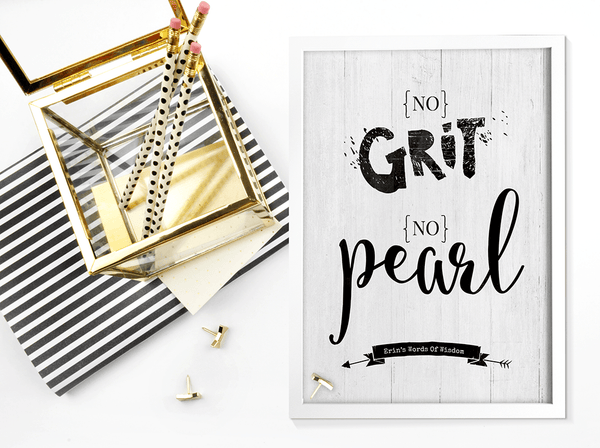 Desk with black and gold accents and a framed No Grit No Pearl personalized print