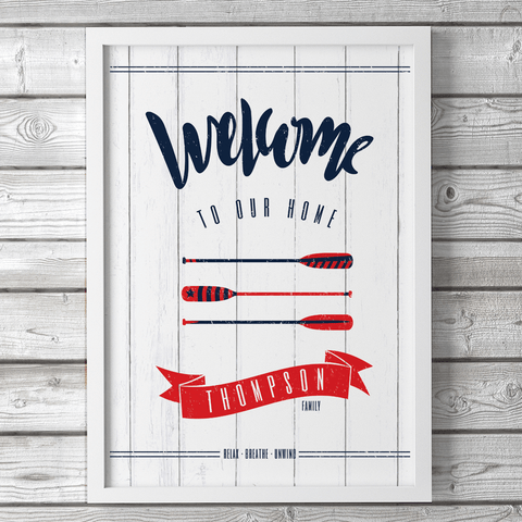 Coastal living design - welcome sign in navy, red and white with oars and your family name set in a red banner.