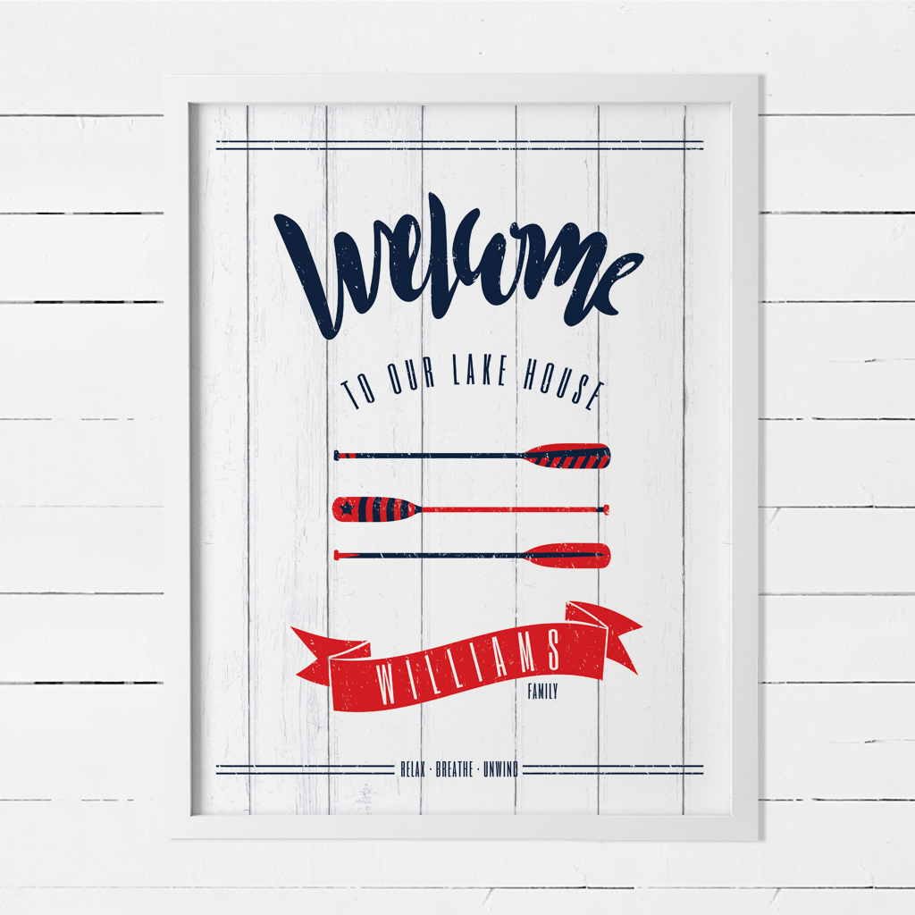 Welcome to our lake house print with a personalize banner below red and navy oars.
