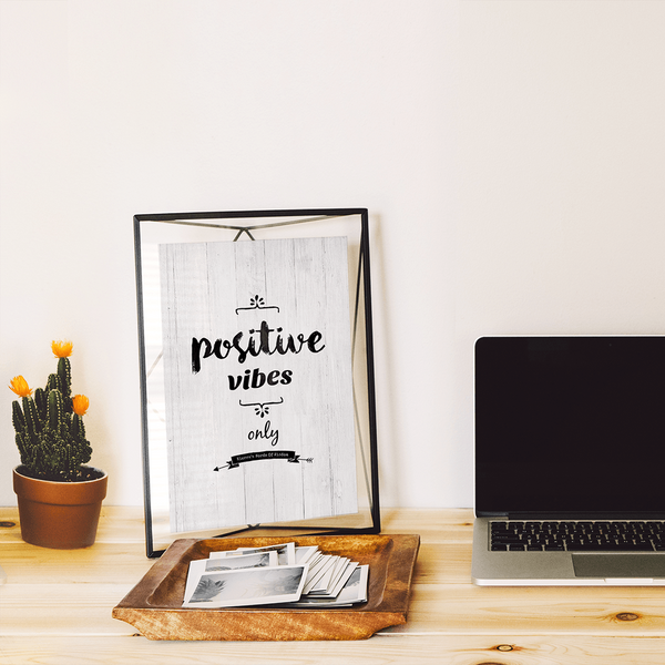 Positive Vibes Only personalized print framed on a desk in a modern workspace