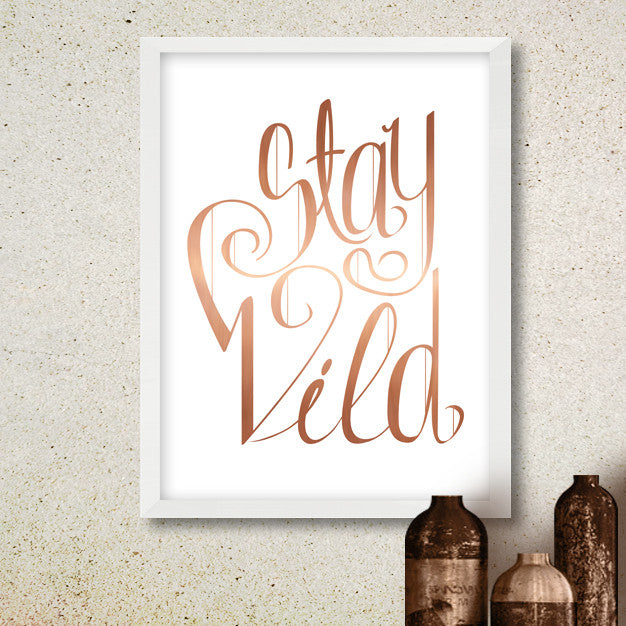 poster with "Stay Wild" written in copper lettering on white background
