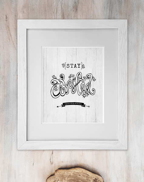 Stay Twisted yoga print framed in a matted frame on rustic background