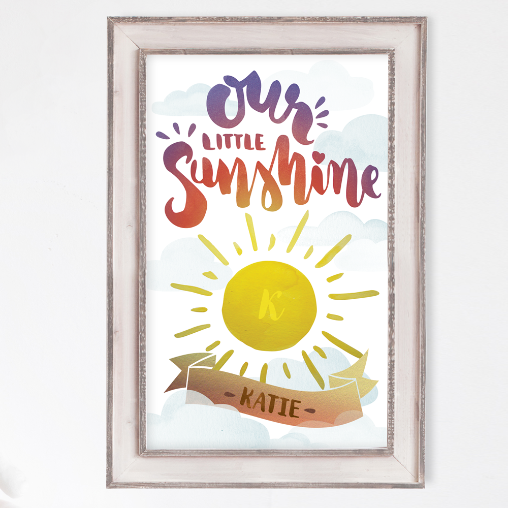 Watercolor of a sun with baby's initial in it. Tagline reads Our Little Sunshine. Baby's name is set in a decorative banner below the sun.