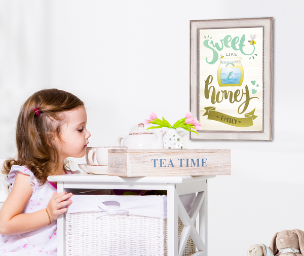 Little girl in her room with Sweet Like Honey print on the wall.