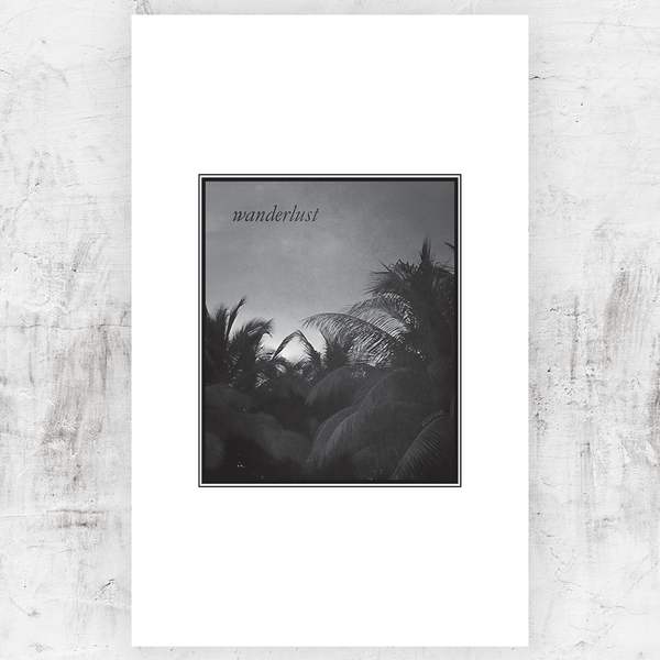 Black and white print of tops of palm trees with a word "Wanderlust" in the sky. Personalize this print with your first name in the trees!
